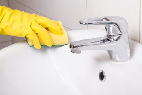 Local team cleaning a hard floor in a Belsizepark home